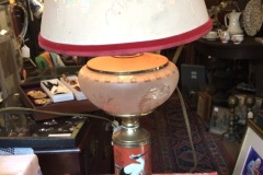 Early Oil Lamp Converted to Electric with Crane on Red Background